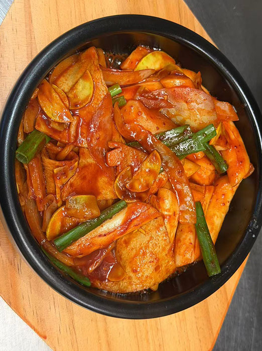 Spicy stir-fried vegetables with green onions in red sauce at Mr.Kimchi Korean Bistro, a Korean Restaurant in Oklahoma City