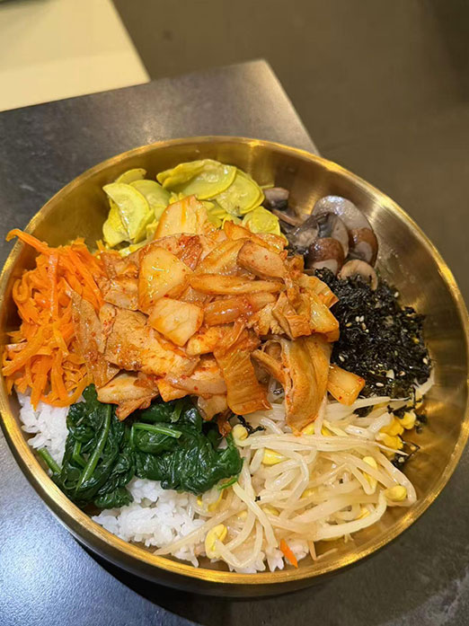 Bibimbap with kimchi, spinach, sprouts, mushrooms, and carrots at Mr.Kimchi Korean Bistro, a Korean Restaurant in Oklahoma City