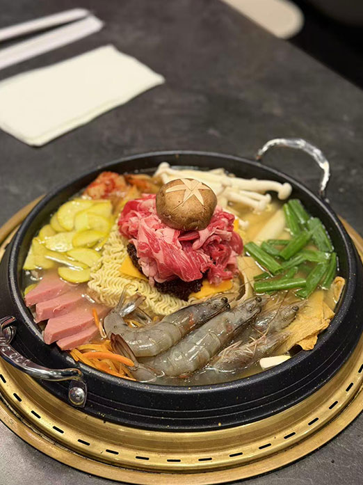 Budae jjigae hot pot with beef, shrimp, noodles, and vegetables at Mr.Kimchi Korean Bistro, a Korean Restaurant in Oklahoma City