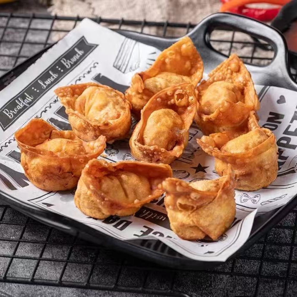Mr-Zhang-Kitchen-Asian-Restaurant-Fried-Dumplings-River-Edge Golden - brown fried dumplings served on a black tray lined with printed paper at Mr Zhang Kitchen, a Asian restaurant in River Edge