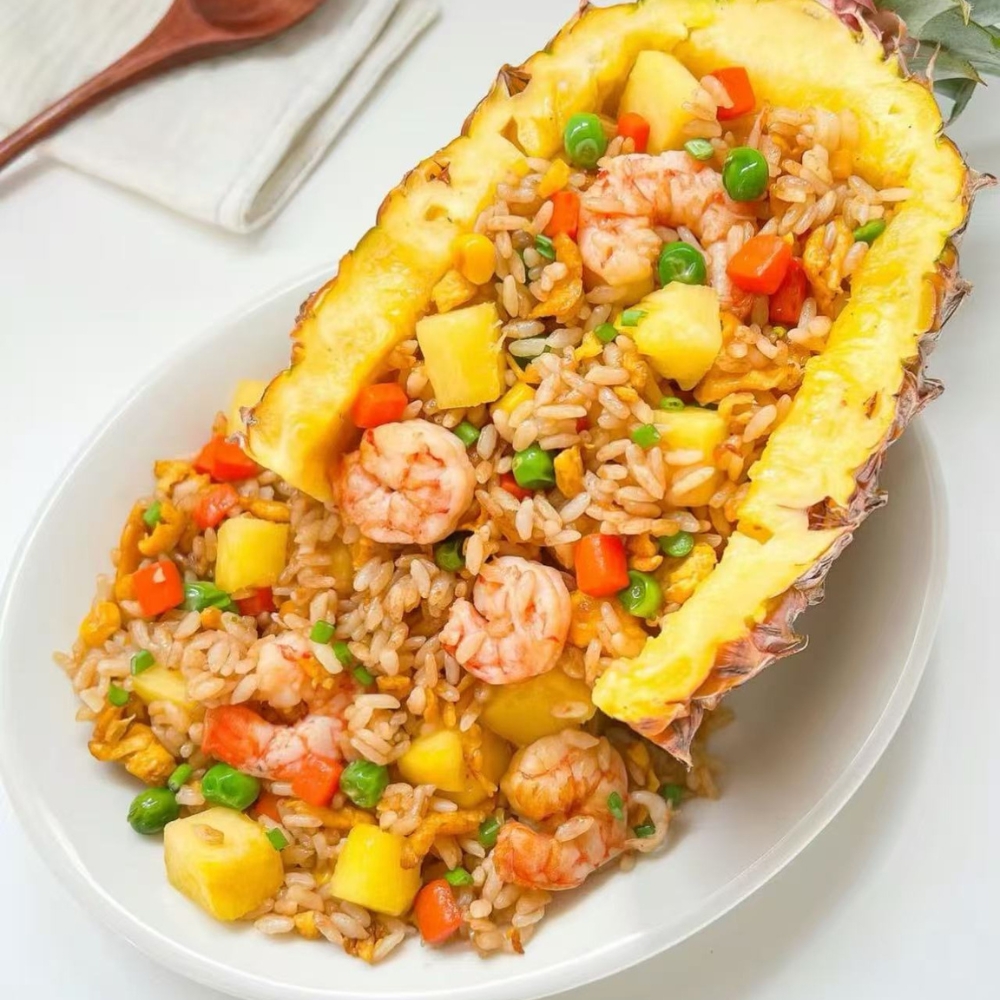 Mr-Zhang-Kitchen-Asian-Restaurant-Pineapple-Fried-Rice-River-Edge Pineapple fried rice with shrimp, peas, and carrots served in a pineapple shell at Mr Zhang Kitchen, a Asian restaurant in River Edge