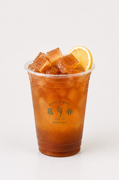 Refreshing iced black tea with clear ice cubes and fresh lemon slice garnish on branded plastic cup at Muchun Isle & Tea, a Bubble Tea Shop in Bayside.
