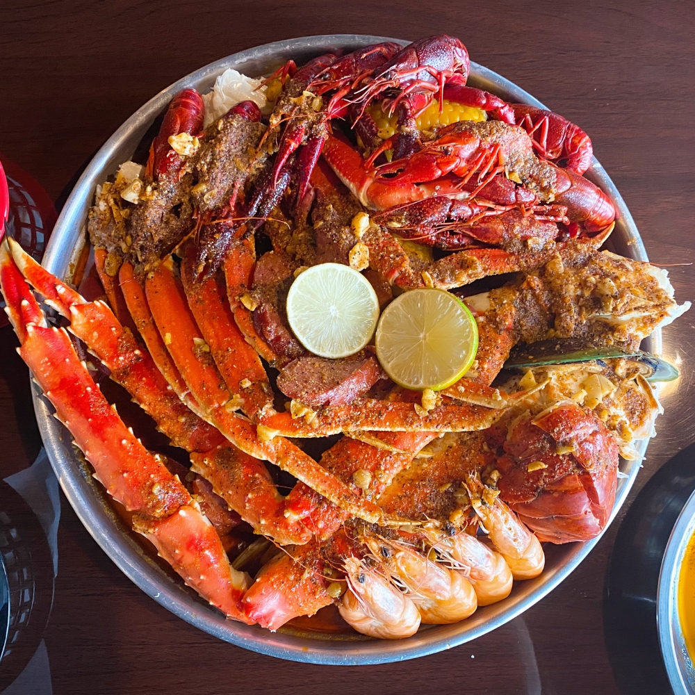 MY-CRAB-SPOT-Seafood-Restaurant-Seafood-Platter-Syracuse Assorted seafood platter with crab legs, crawfish, shrimps and lime at MY CRAB SPOT, a Seafood Restaurant in Syracuse