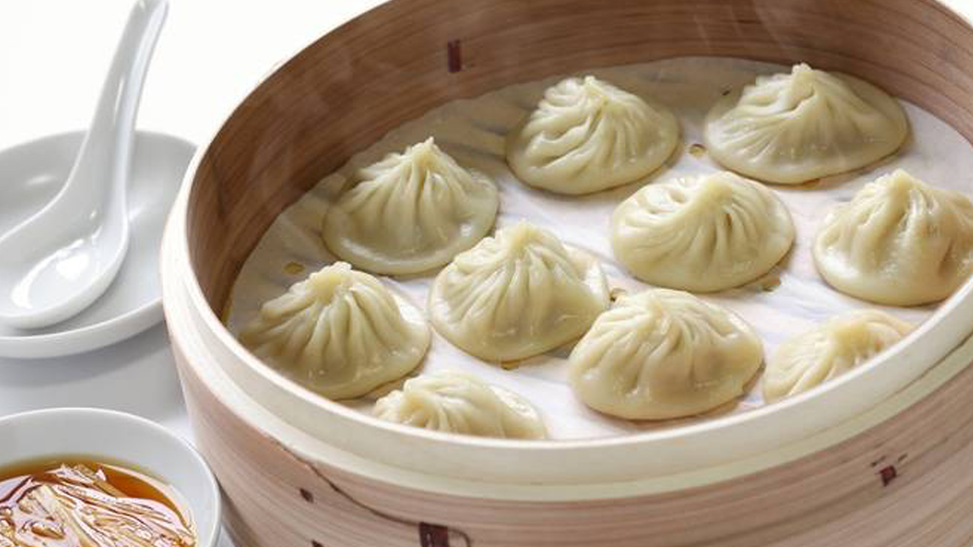 Steamed soup dumplings in a bamboo basket