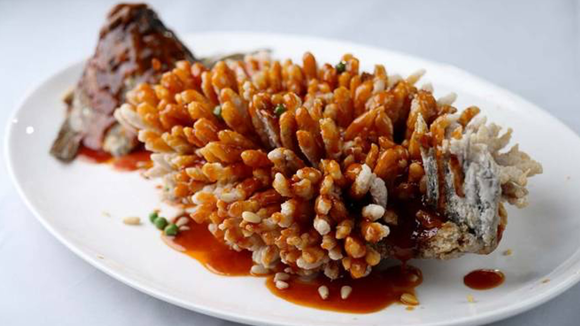 Sweet and sour sliced fish with crispy rice