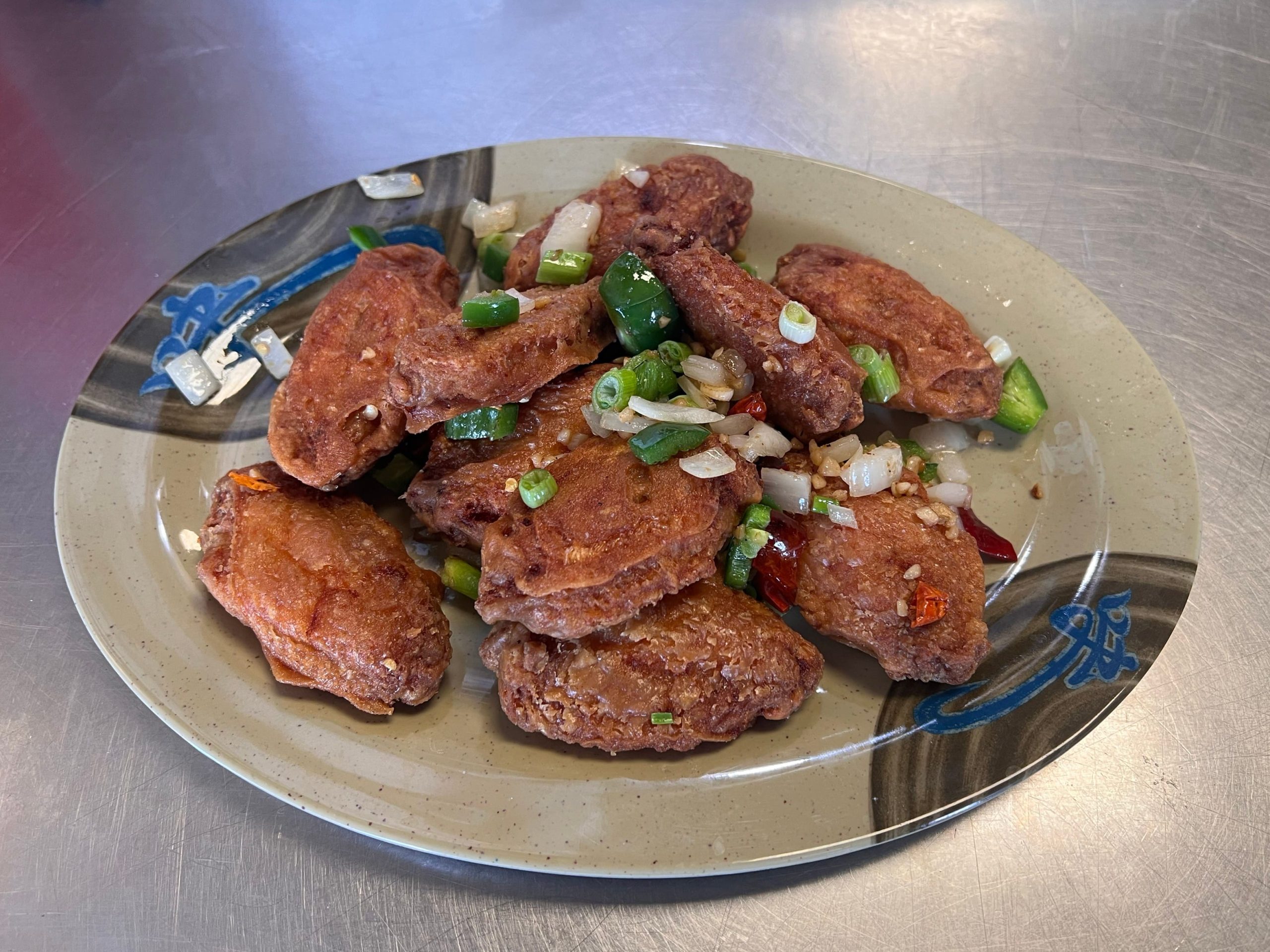 Salt and pepper chicken wings with green onion at Neighborhood Kitchen, a Chinese Restaurant in Fairfield