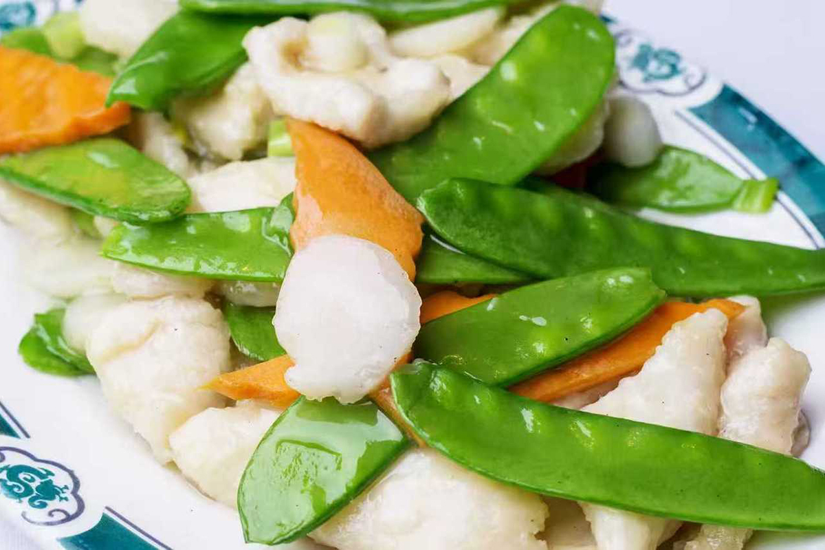 Stir-fried fish fillets with snow peas and carrots in a light sauce at New China Two，a Chinese Restaurant in Redding