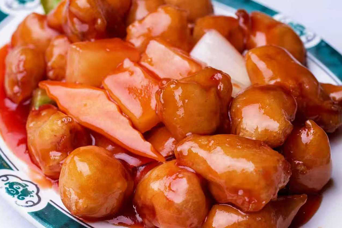 Sweet and sour chicken with pineapple, carrots, and onions in a glossy red sauce at New China Two，a Chinese Restaurant in Redding