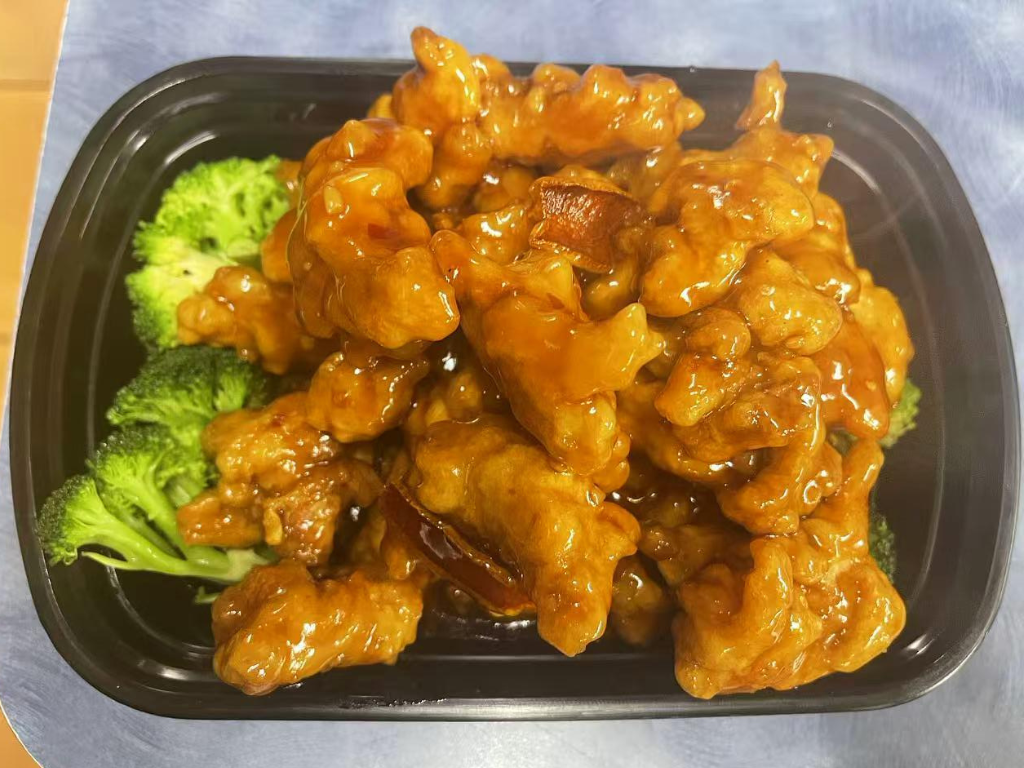 Crispy orange chicken with glossy sauce and broccoli at New China City, a Chinese Restaurant in Roanoke