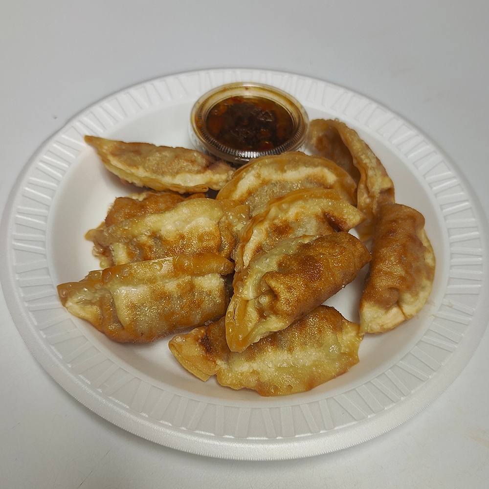 Crispy pan-fried dumplings served with dipping sauce at New China King, a Chinese Restaurant in Ardmore