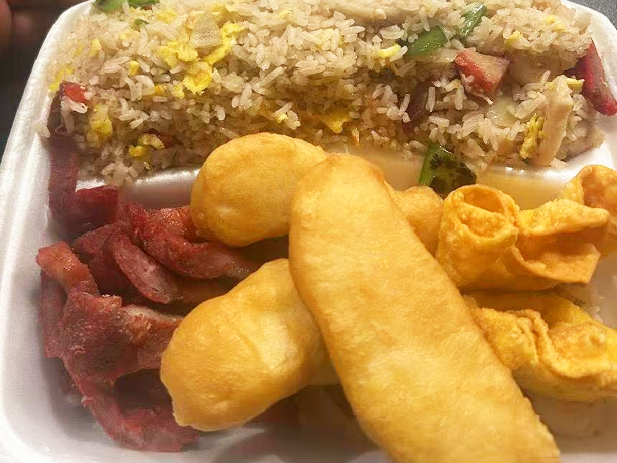 Takeout box with fried rice, sausages and fried dough sticks at New Golden Abacus, a Chinese Restaurant in Norwood