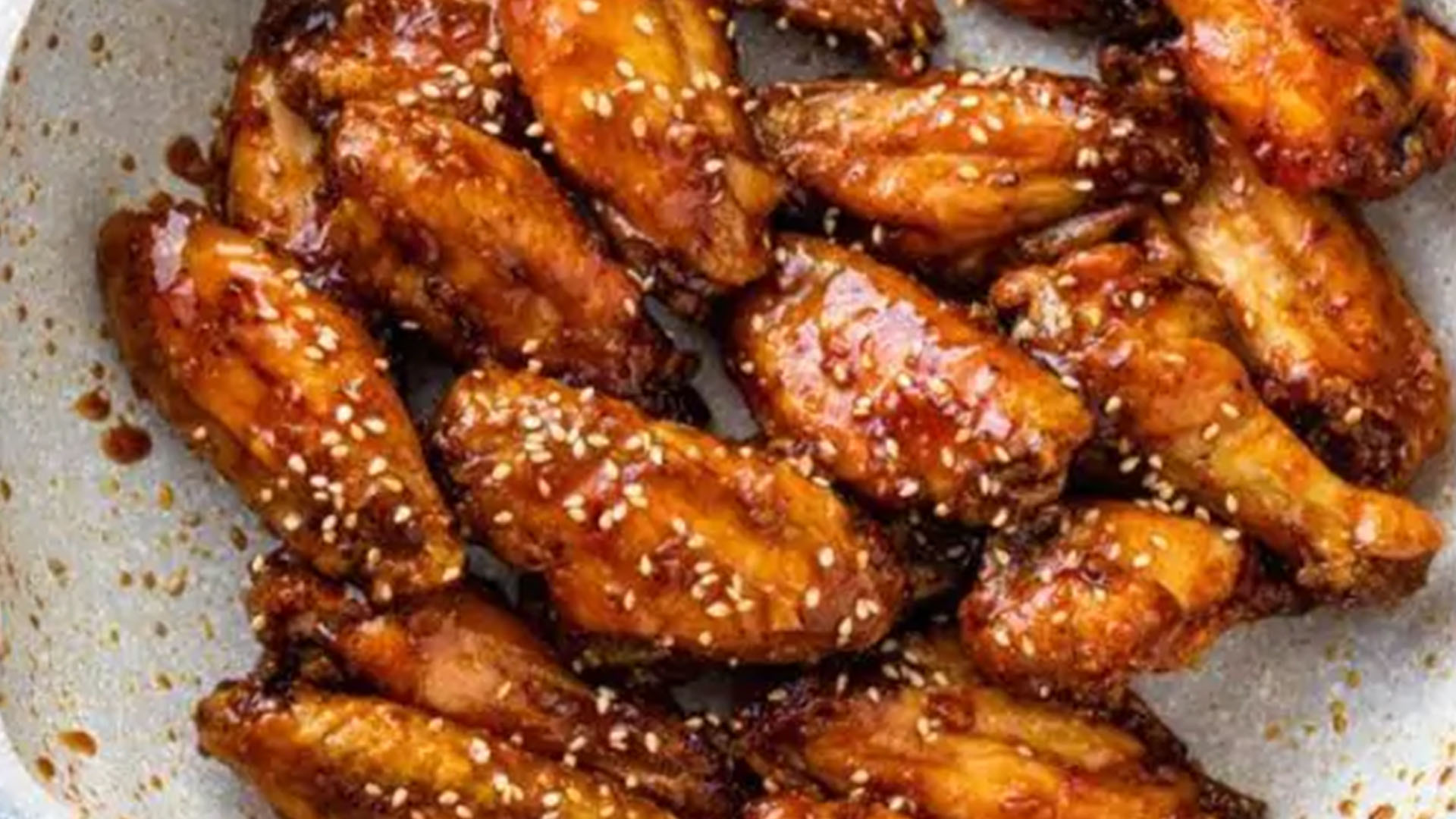 Fried chicken wings in garlic sauce with sesame at New Great Wall, a Chinese Restaurant in Brooklyn