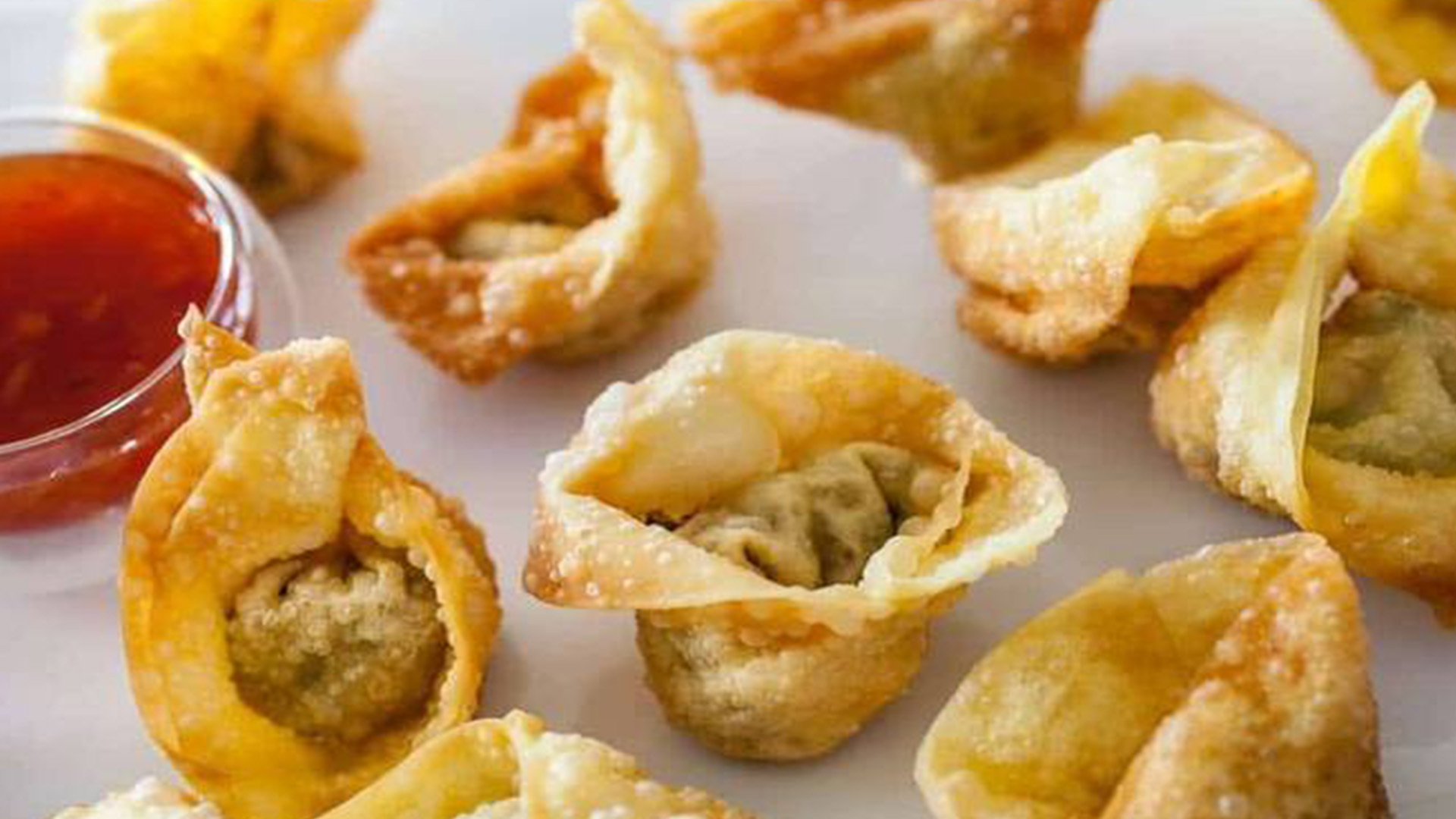 Crispy fried wonton with dipping sauce at New Great Wall, a Chinese Restaurant in Brooklyn