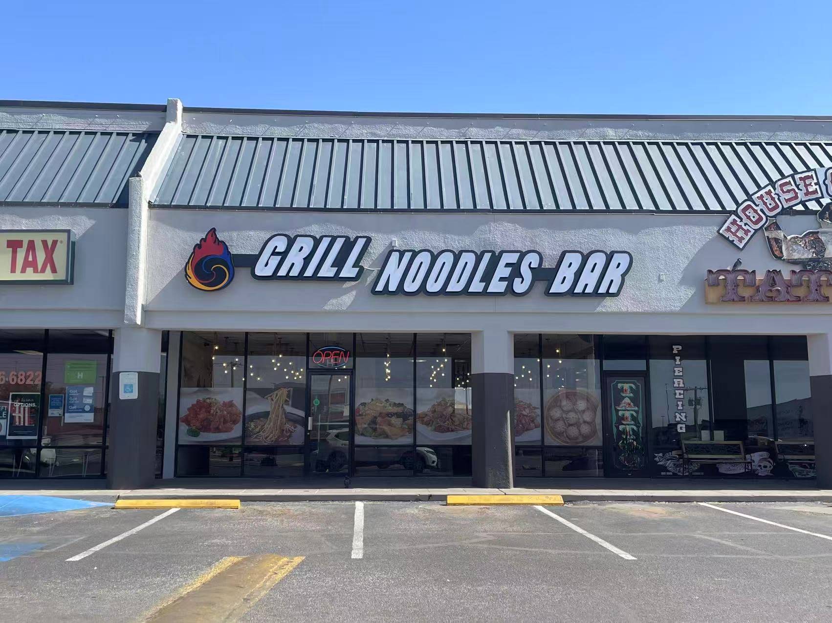Exterior storefront of Grill Noodles Bar with branded signage and food window decals at Grill Noodles Bar, a Chinese Restaurant in El Paso
