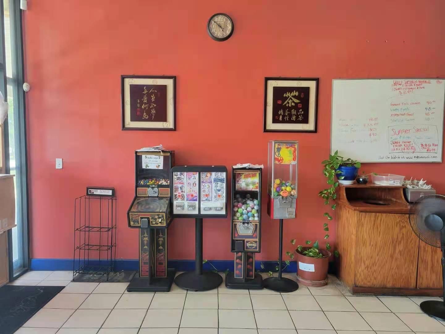 Lobby wall with vending machines, Chinese calligraphy art and wall clock at New Hunan Wok, a Chinese restaurant in Jacksonville