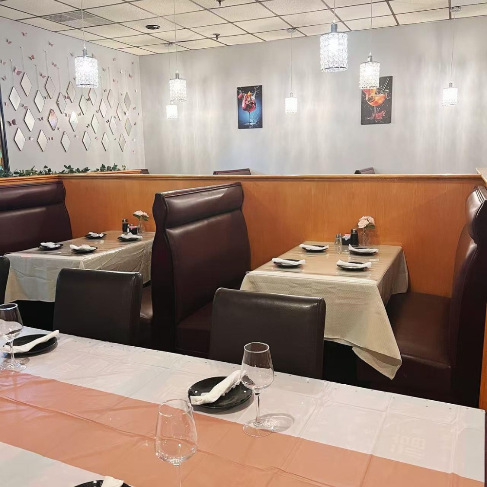 The dining area with booths and tables set for meals at New Imperial, a Chinese Restaurant in Easton.
