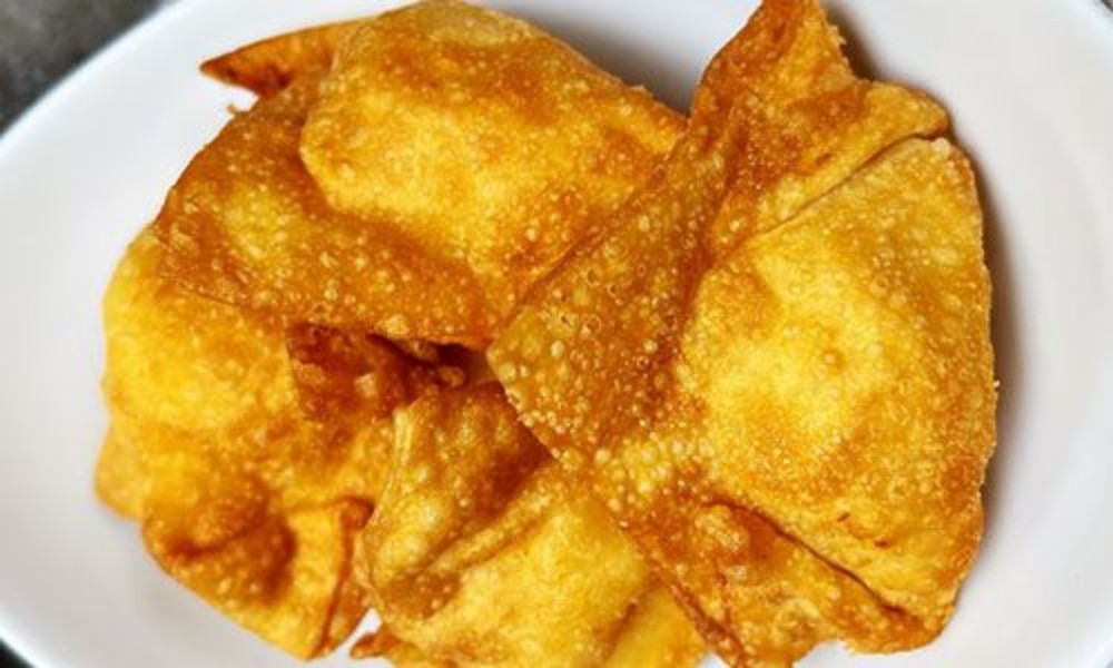 Golden crispy fried wontons served on plate at New Ing's Palace, a Asian Restaurant in Burbank