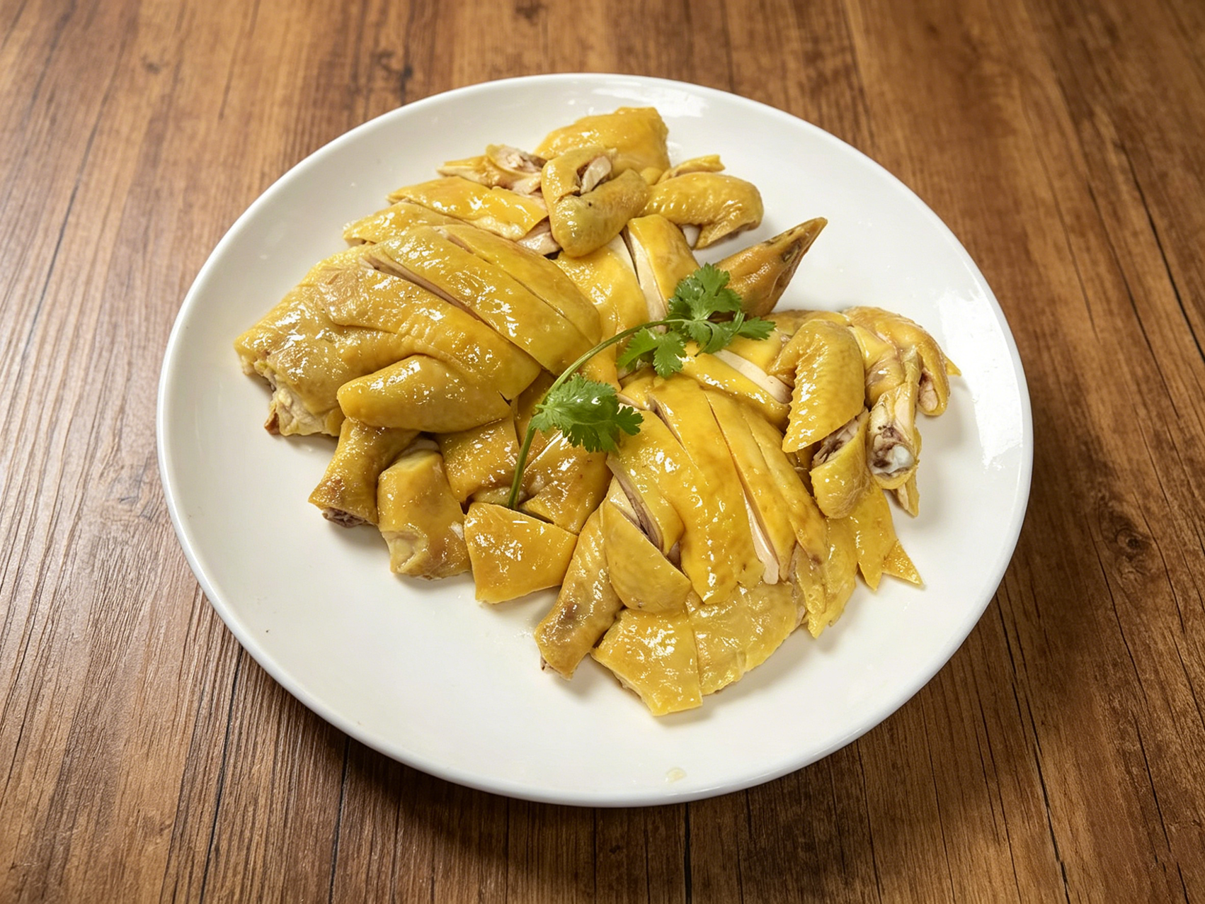 Traditional poached chicken on a wooden table at New Northern Manor, a Chinese Seafood Restaurant in Queens
