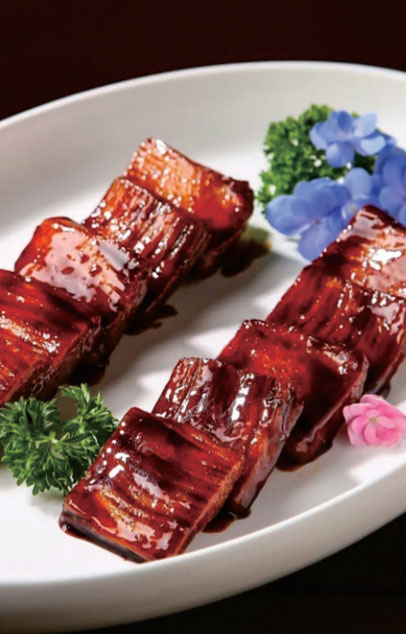 Braised pork belly cubes with flower garnish at New Shanghai No. 1, a Chinese restaurant in San Gabriel