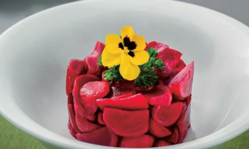 Red beetroot salad topped with yellow edible flower at New Shanghai No. 1, a Chinese restaurant in San Gabriel