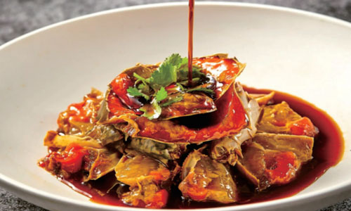 Braised crab pieces in red sauce with cilantro at New Shanghai No. 1, a Chinese restaurant in San Gabriel