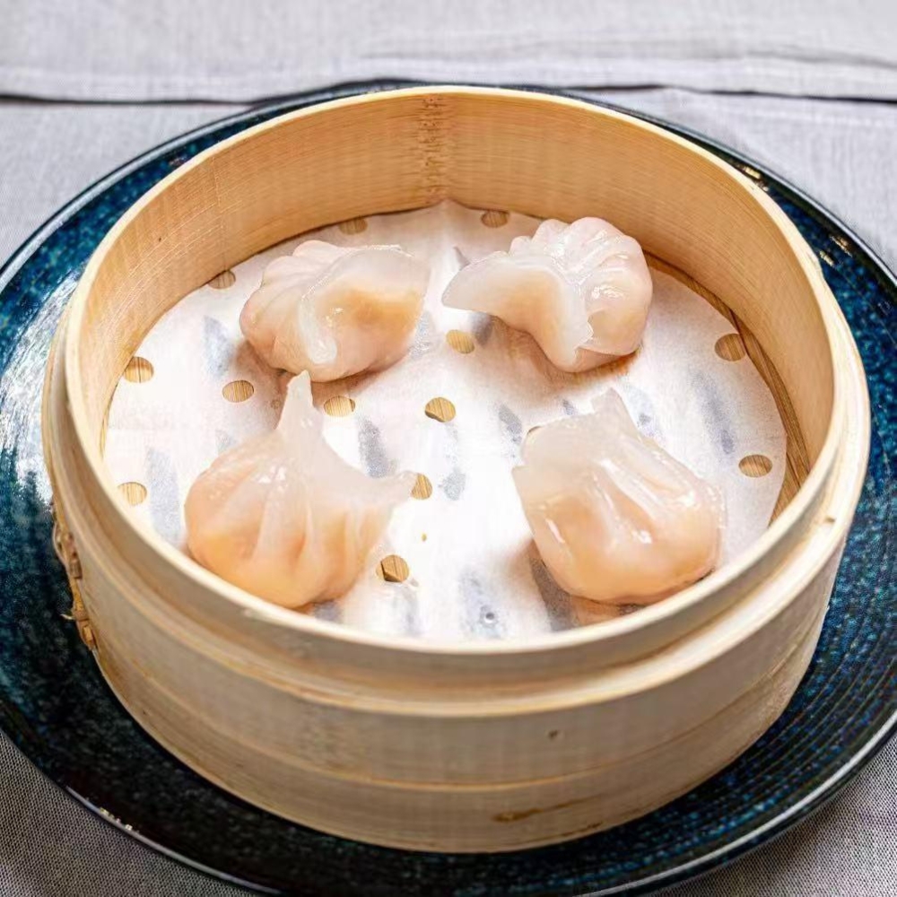 Steamed shrimp dumplings served in bamboo steamer at New Tokyo Sushi, a Sushi Restaurant in Jamaica