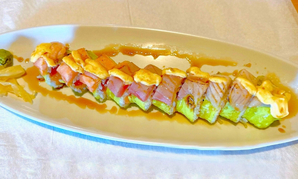 Rainbow roll with assorted fish, yellow sauce, and teriyaki at New Tokyo & Ichiban Japanese Grill, a Japanese Restaurant in Tupelo