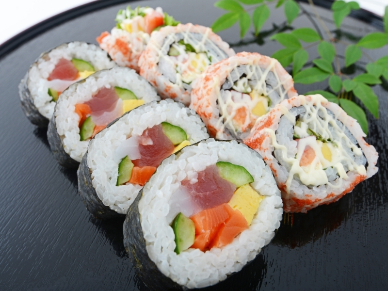 Assorted sushi rolls with tuna, salmon, and creamy toppings at Ninja Cafe - Kung Fu Tea, a Bubble Tea Store in High Point
