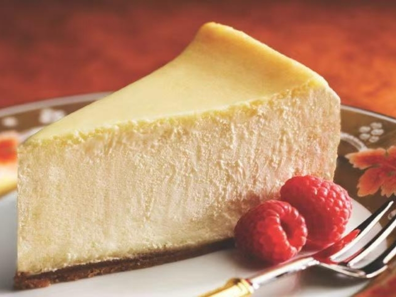 Classic cheesecake with raspberries, rich and creamy at Ninja Ramen, a Japanese Restaurant in Englewood