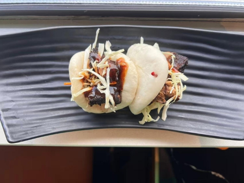 Soft buns with braised pork, cabbage, and sauce at Ninja Ramen, a Japanese Restaurant in Englewood