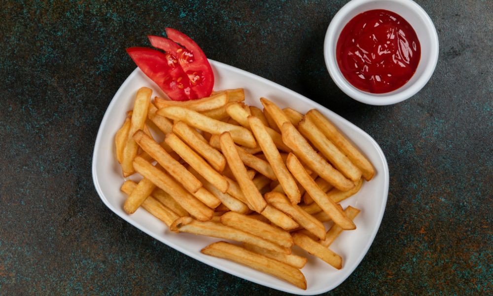 Golden French fries with tomato garnish and ketchup dip at Noodle House, a Japanese Sushi Restaurant in Flemington