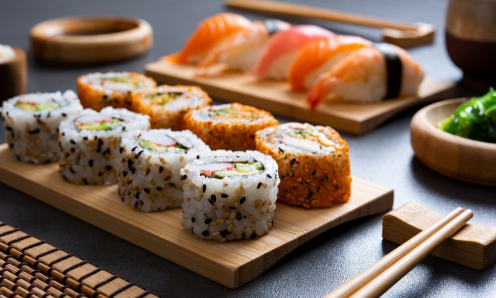 Assorted sushi rolls and nigiri served on a wooden platter at Noodle House, a Japanese Sushi Restaurant in Flemington