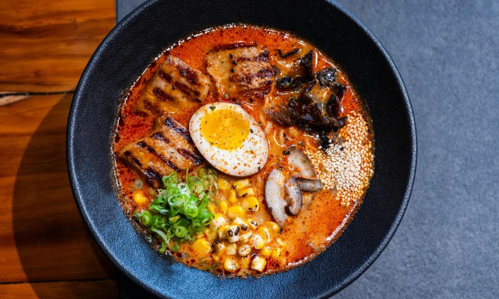 Spicy ramen with grilled pork, soft-boiled egg, and sesame seeds at Noodle House, a Japanese Sushi Restaurant in Flemington
