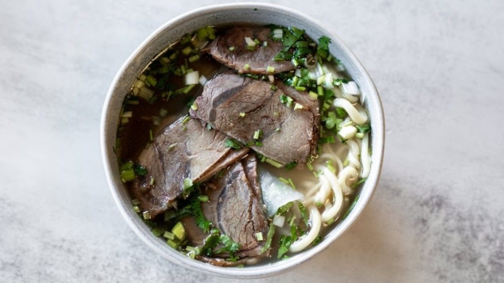 Beef noodle soup with sliced beef and fresh herbs at Noodle Man , a Noodle shop in Virginia Beach