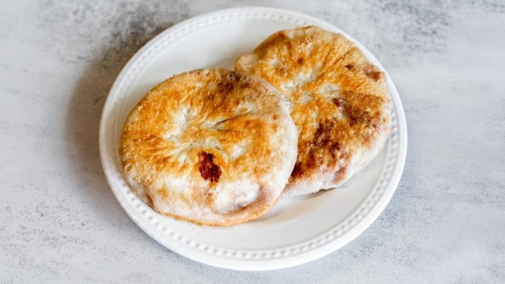 Two golden brown crispy pan-fried pastries on a plate at Noodle Man , a Noodle shop in Virginia Beach