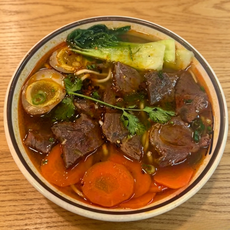 Spicy beef soup noodle with veggies at Noodle・ology, a Asian Restaurant in Edmond Spicy beef soup noodle with veggies at Noodle・ology, a Asian Restaurant in Edmond