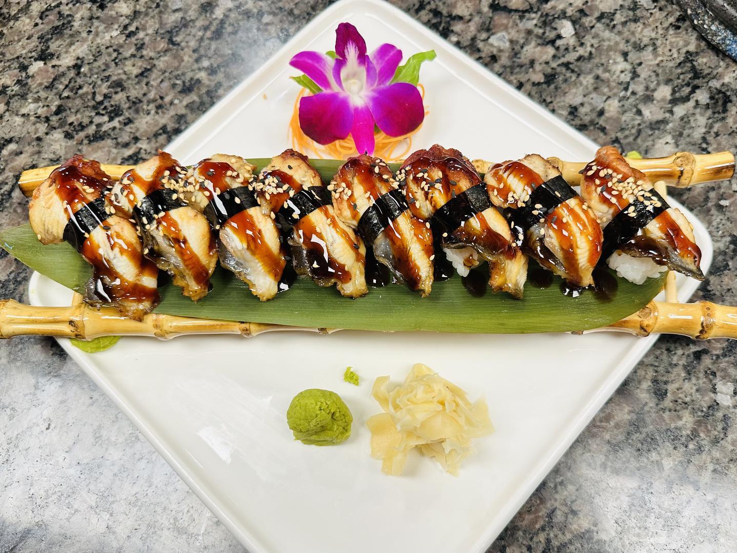 Noriya-Japanese-Cuisine-Restaurant-Eel-Sushi-Roll-Decatur Eel sushi rolls garnished with sesame seeds and a decorative flower at Noriya Japanese Cuisine, a Japanese Restaurant in Decatur