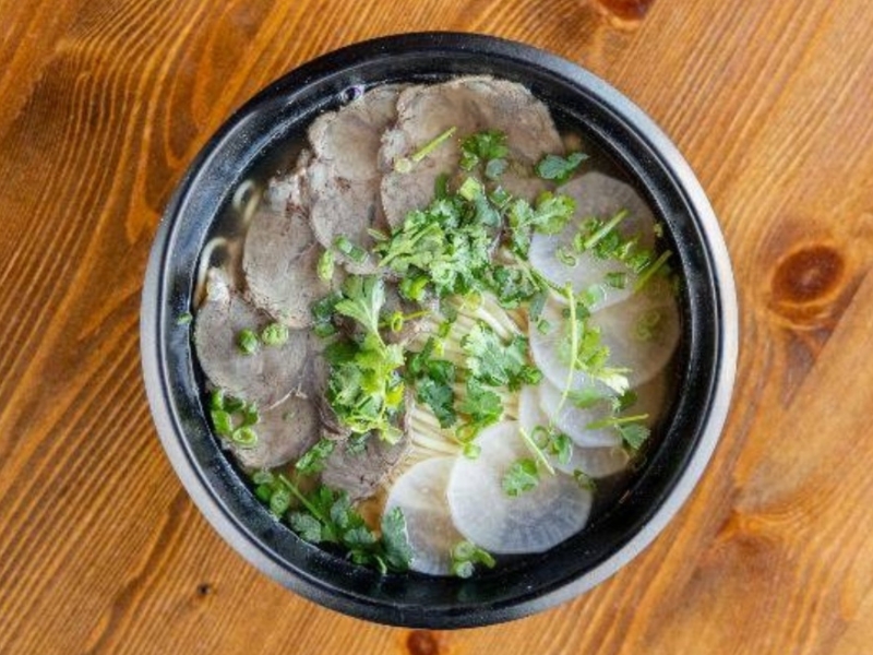 Clear beef noodle soup with radish slices and cilantro at Northern Cafe, a Chinese Restaurant in CA