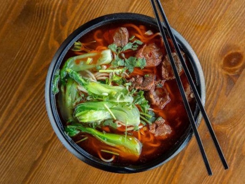 Spicy beef noodle soup with bok choy and cilantro at Northern Cafe, a Chinese Restaurant in CA