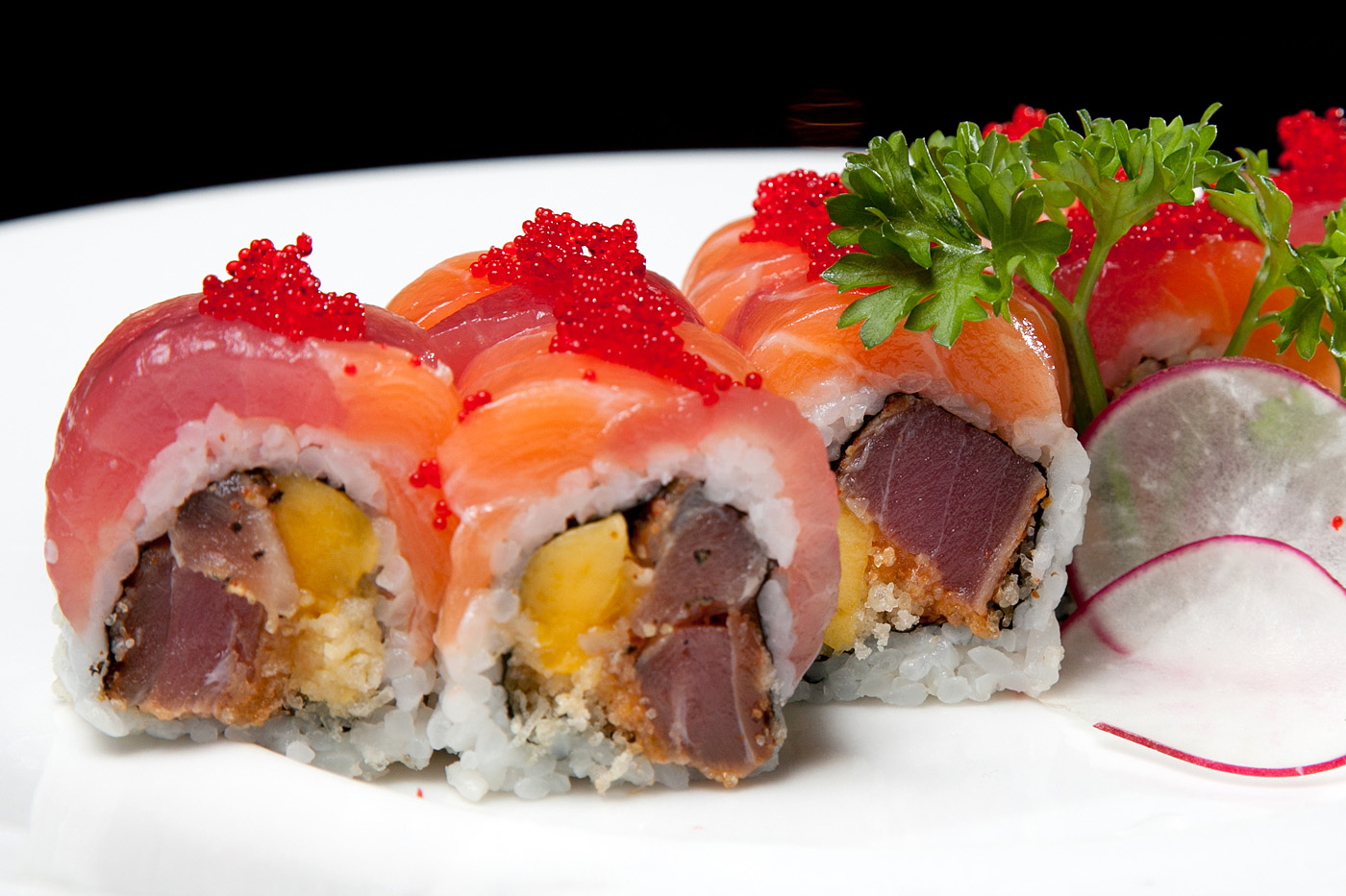 Premium salmon tuna sushi rolls topped with fish roe at Ocha Asian-Japanese Cuisine，a Asian Restaurant in Caldwell