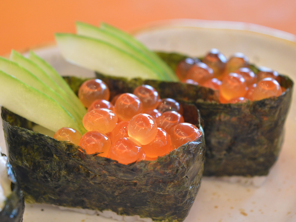 Salmon roe sushi garnished with cucumber slices at Oishii Express, a Japanese Restaurant in Oklahoma City