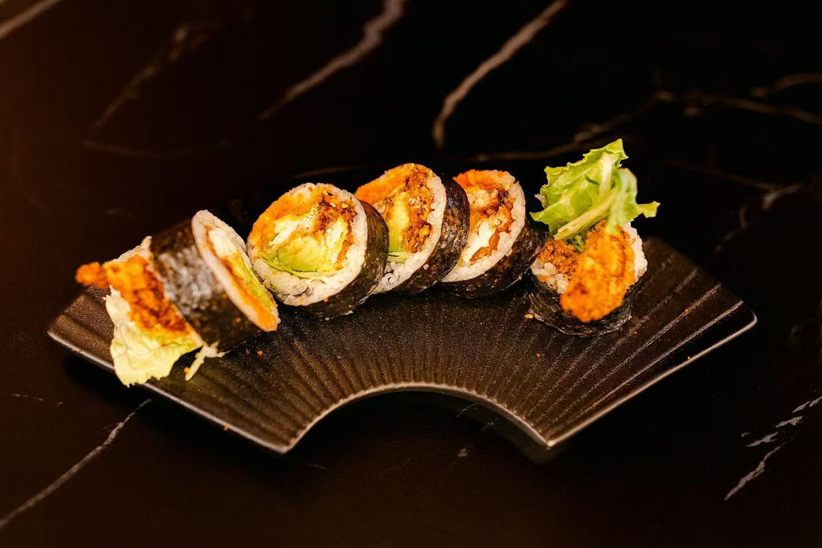 Crispy soft shell crab with lettuce, avocado, and masago wrapped in seaweed and sushi rice at Oishii Express, a Japanese Restaurant in Oklahoma City