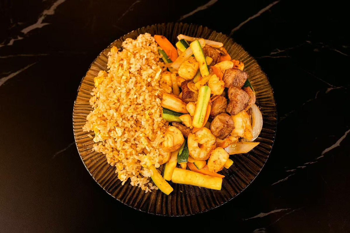 Grilled chicken, steak, and shrimp served with mushrooms, zucchini, carrots, onions and fried rice at Oishii Express, a Japanese Restaurant in Oklahoma City