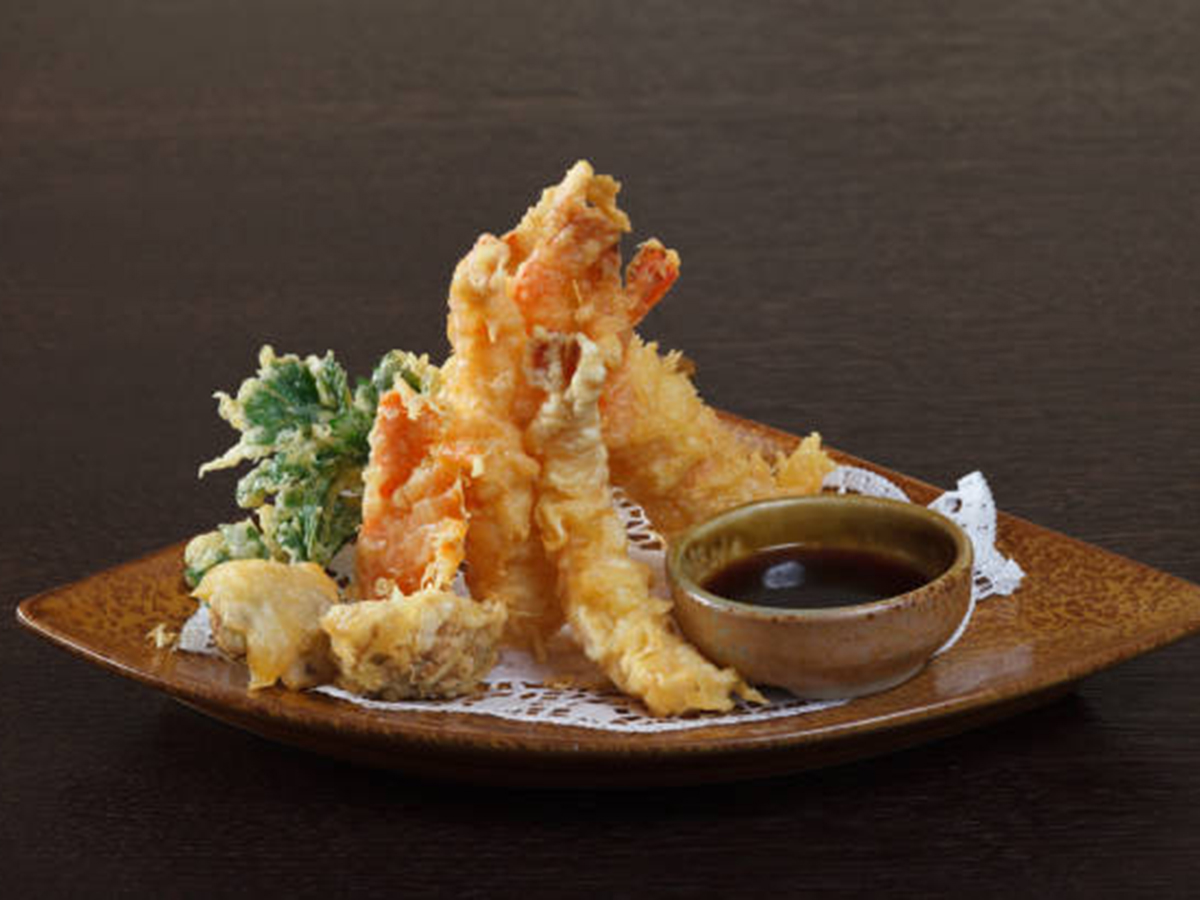 Crispy shrimp tempura served with dipping sauce at Oishii Express, a Japanese Restaurant in Oklahoma City