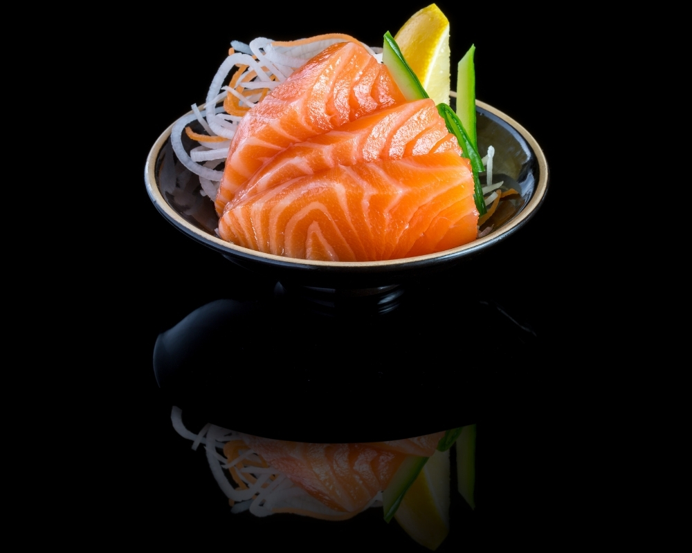 Fresh salmon sashimi served in a bowl at Oishii Sushi House, a Japanese Restaurant in Dacula.
