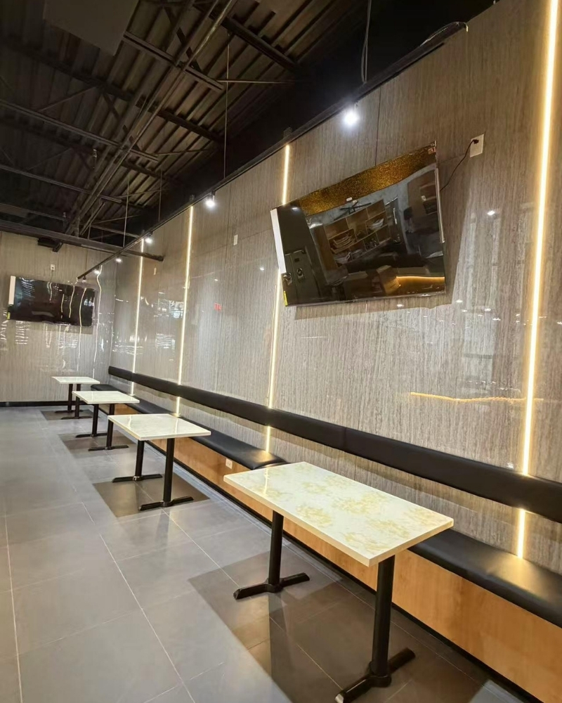 Sleek wall-side seating with minimalist tables at Oishii Sushi House, a Japanese Restaurant in Dacula.