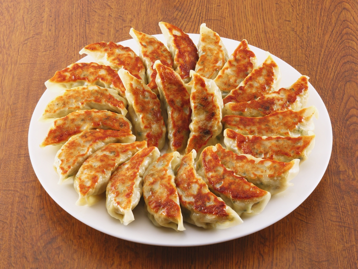 Pan-fried dumplings arranged on white plate at One More Bite Dumpling, a Chinese Restaurant in Palm Desert