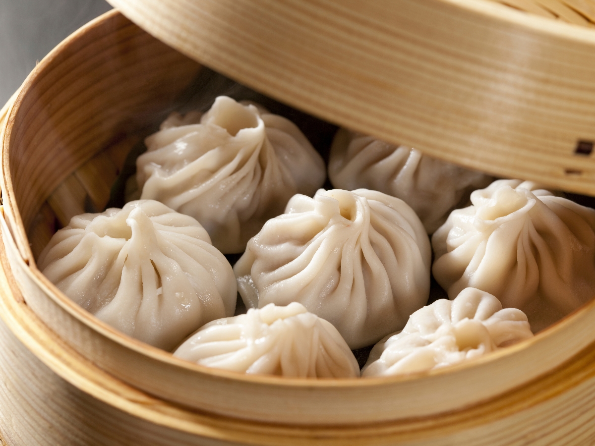 Steamed soup dumplings in bamboo steamer at One More Bite Dumpling, a Chinese Restaurant in Palm Desert