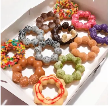 Colorful assorted mochi donuts in a box at OneZo，a Bubble Tea Store in Brookline