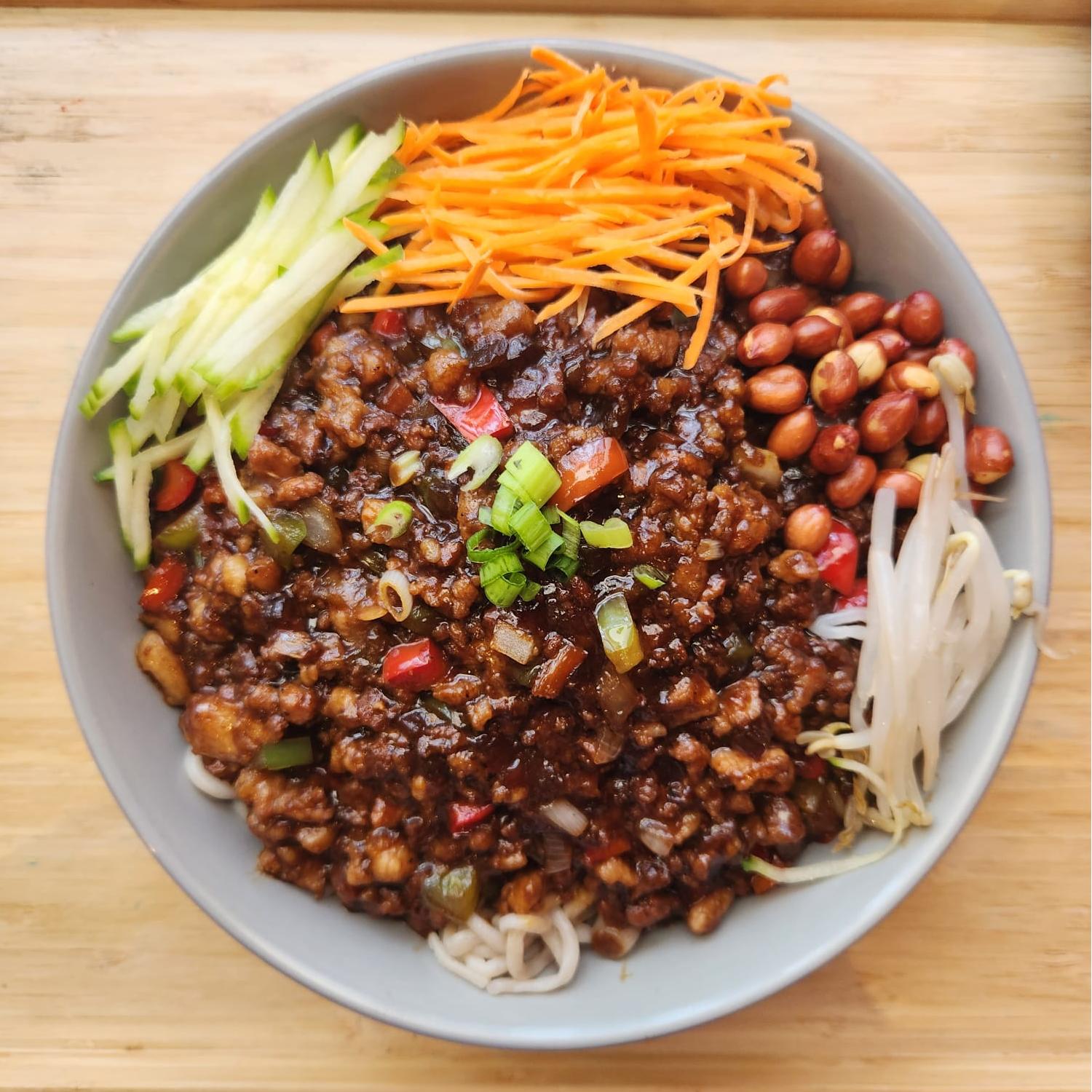 Noodles topped with spicy minced pork, peanuts, shredded carrots at Opera House, a Chinese restaurant in Philadelphia